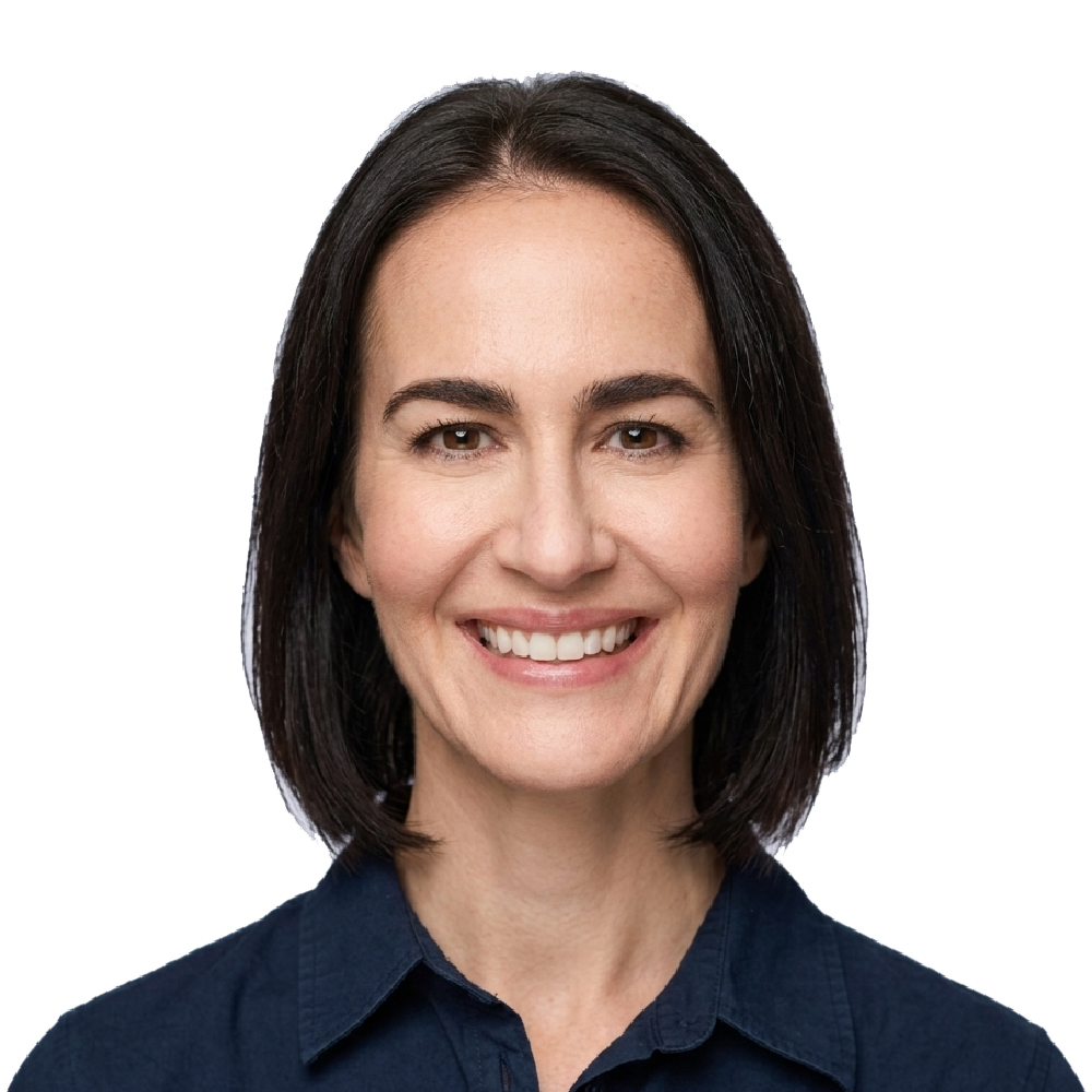 Woman with straight, dark hair in a navy collared shirt smiling at the camera against a plain white background.